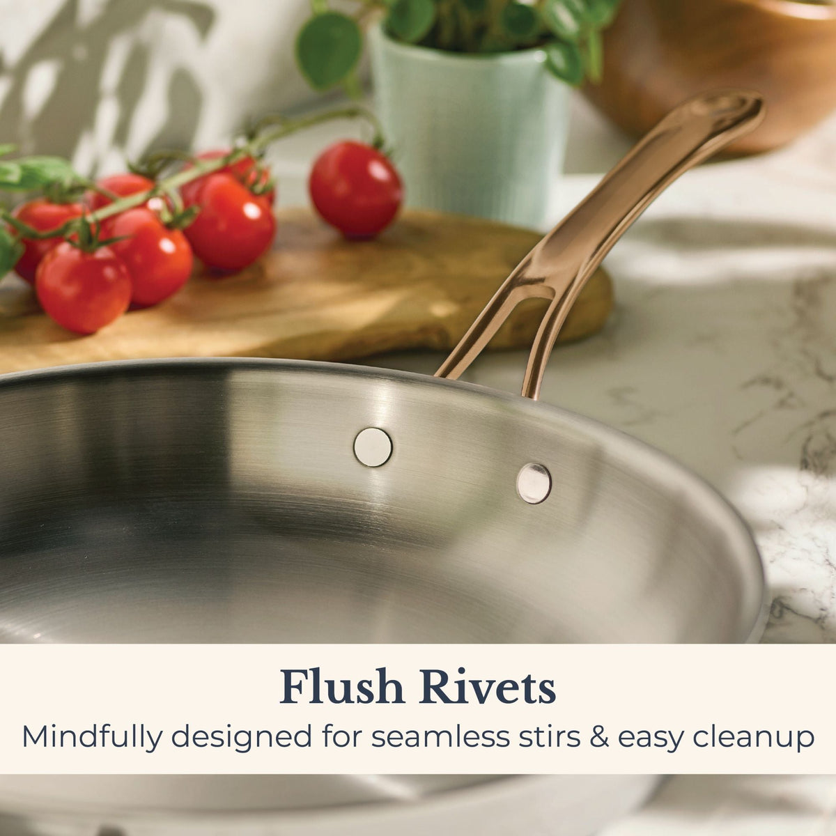 Close-up of flush rivets inside an Anolon EverLast stainless steel skillet with bronze handle, designed for easy stirring and cleanup